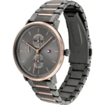 Men's stainless steel wristwatch with gray dial, rose-gold bezel and accents, and a two-tone metal bracelet featuring the Tommy Hilfiger logo.