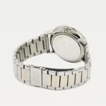 Stainless steel wristwatch with a metal link band viewed from the side, showing the case back and crown capacity side.