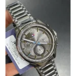 1791975_01 Silver-toned Hilfiger chronograph wristwatch with metal link band, tachymeter bezel, and multiple subdials; brand logo visible on dial.