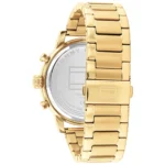 Gold-tone stainless steel watch with metal link band and clasp, back shows TOMMY HILFIGER engraving.