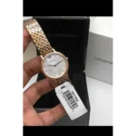 Rose gold Emporio Armani wristwatch with a white dial and crystal markers held over a black box.