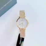Gold-toned Emporio Armani wristwatch with a white dial and crystal hour markers on a white surface near a box.