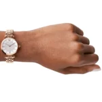 ar11223-emporio-armani-watch-women-pink-dial-stainless-steel-metal-silver-rose-gold-strap-quartz-battery-analog-gianni-t-bar_100 Rose gold metal wristwatch on a left wrist, white dial with Roman numerals and a sparkling center band pattern.