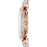 Side view of a rose-gold wristwatch with a white strap and crown on the case.