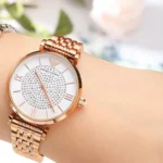 ar11223-emporio-armani-watch-women-pink-dial-stainless-steel-metal-silver-rose-gold-strap-quartz-battery-analog-gianni-t-bar_91 Rose gold wristwatch with a crystal-studded dial on the wrist, featuring a linked metal band