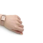 ar11347-emporio-armani-watch-square-women-rose-gold-dial-mesh-stainless-steel-metal-rose-gold-strap-quartz-battery-analog-gioia_9_1024x1024 Wrist wearing a rose-gold mesh band watch with a square face on a pale hand