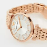 Rose gold Emporio Armani wristwatch with a diamond-studded bezel and white dial with gold hands.