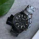 ar1452-emporio-armani-watch_100 Black Emporio Armani ceramic wristwatch with a dark dial and multiple subdials on a gray surface.