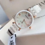 ar1486-emporio-armani-watch-ceramica-women-mother-of-pearl-white-dial-ceramic-strap-quartz-battery-analog-gianni-t-bar_8 Emporio Armani women's ceramic wristwatch with a white band, rose-gold accents, and a mother-of-pearl dial showing time.