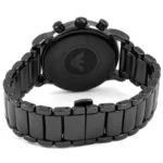 Back view of a black stainless steel wristwatch with a multi-link bracelet on white surface, showing the case back.
