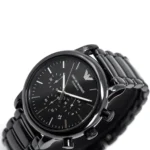 Black stainless-steel Emporio Armani chronograph wristwatch with three subdials and date window on a metal link bracelet.