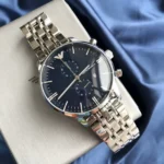 Emporio Armani stainless steel chronograph watch with a dark blue dial, multiple subdials, and date window on a light surface edge.