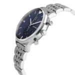 Silver metal wristwatch with a blue dial and multiple subdials, angled to show the polished bracelet and crown