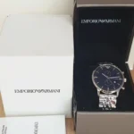 Emporio Armani men's stainless steel watch with a dark blue dial in its black box.