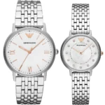 Pair of Emporio Armani watches with silver metal bracelets, white dials, and rose-gold hands; left is a larger men’s style, right a smaller women’s style with crystals.