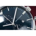Close-up of a dark blue Emporio Armani chronograph watch face with silver hands and subdials, date window at 3 o'clock.