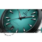 omega-seamaster-aqua-terra-150m-co-axial-master-chronometer-41mm-automatic-men_3 Close-up of teal Omega Seamaster watch dial with silver hour markers, hands, and date window near 7 o'clock.