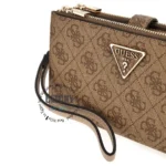 Brown Guess crossbody bag with monogram pattern, gold zipper, and triangular logo plate; leather strap visible on the side