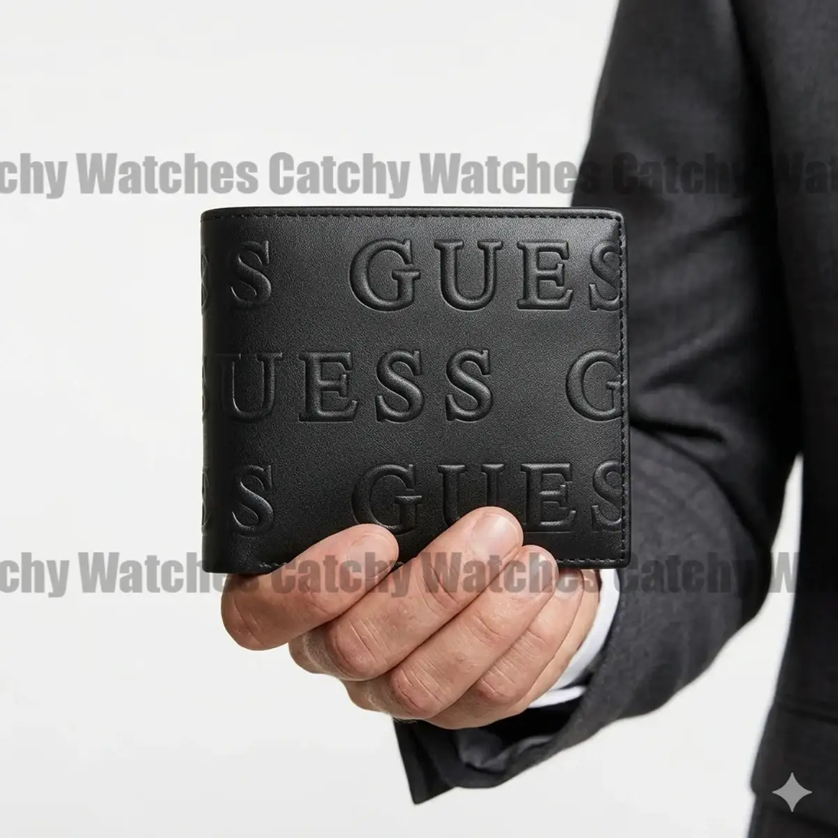 Black leather wallet with a raised GUESS logo pattern held by a hand in a suit jacket; watermark across image.