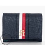 original-tommy-hilfiger-wallet-women-navy-blue-genuine-leather Navy pebbled leather wallet with white and red vertical stripes and a gold-tone TH logo in the center.