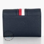 original-tommy-hilfiger-wallet-women-navy-blue-genuine-leather_5 Navy blue pebbled leather wallet with a red and white stripe on the top edge.
