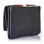 original-tommy-hilfiger-wallet-women-navy-blue-genuine-leather_6 Side view of a black pebble-grain leather wallet with a zip closure and gold-tone chain detail on top; compact card case.