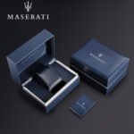 Blue Maserati gift set featuring an open box with a dark blue leather accessory, plus a matching closed box and a small Maserati booklet.
