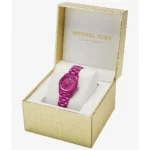 Pink Michael Kors Limited Edition wristwatch in a gold crocodile-skin box on a white cushion
