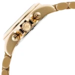 Close-up of a gold-toned Michael Kors watch case and bracelet, highlighting the crown with the MK logo and adjacent pushers