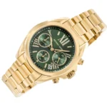 Gold-tone Michael Kors wristwatch with a green dial, three subdials, date window, and metal link band.