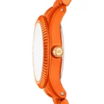 Side view of an orange Michael Kors watch with a knurled bezel and gold MK crown.