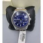 mk8280-michael-kors-watch-men-blue-dial-metal-stainless-steel-silver-strap-quartz-battery-analog-chronograph-lexington_108 Michael Kors stainless steel chronograph watch with a blue dial on a black cushioned display, tag visible.