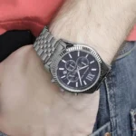 mk8280-michael-kors-watch-men-blue-dial-metal-stainless-steel-silver-strap-quartz-battery-analog-chronograph-lexington_12 Stainless steel wristwatch with a blue dial and three subdials on a man's wrist.