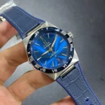 Omega wristwatch with blue sunburst dial and matching blue strap, stainless steel case; date window at 6 o'clock.