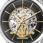 Skeleton wristwatch with gold hands and Maserati trident emblem, visible gears through the dial.