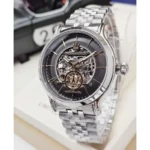 Stainless steel Maserati wristwatch with a skeleton dial and visible gears, silver bracelet, crown at 3 o'clock