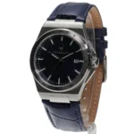 Stainless steel wristwatch with a dark blue textured dial and blue leather strap, showing a date window at 3 o'clock.
