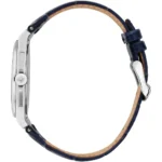 Side view of a stainless steel wristwatch with a blue leather strap and beige inner lining, showing the crown with a logo.