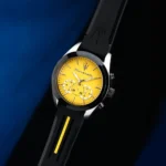 Maserati wristwatch with a bright yellow dial, black bezel, and black strap with a yellow stripe.