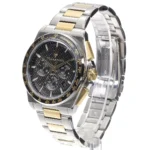 Two-tone stainless steel watch with black textured dial and gold accents, featuring a tachymeter bezel