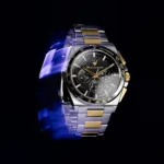 Two-tone stainless steel chronograph watch with a black textured dial and gold accents, tachymeter bezel.